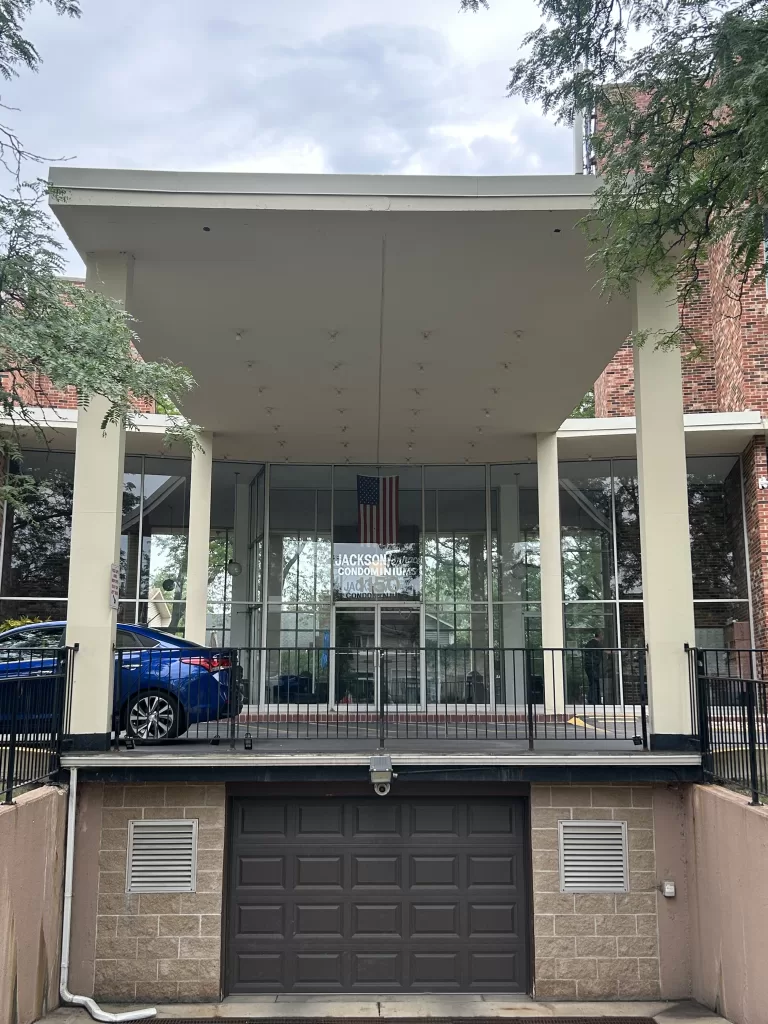 Completed property exterior renovation featuring modernized entrance and landscaping improvements.