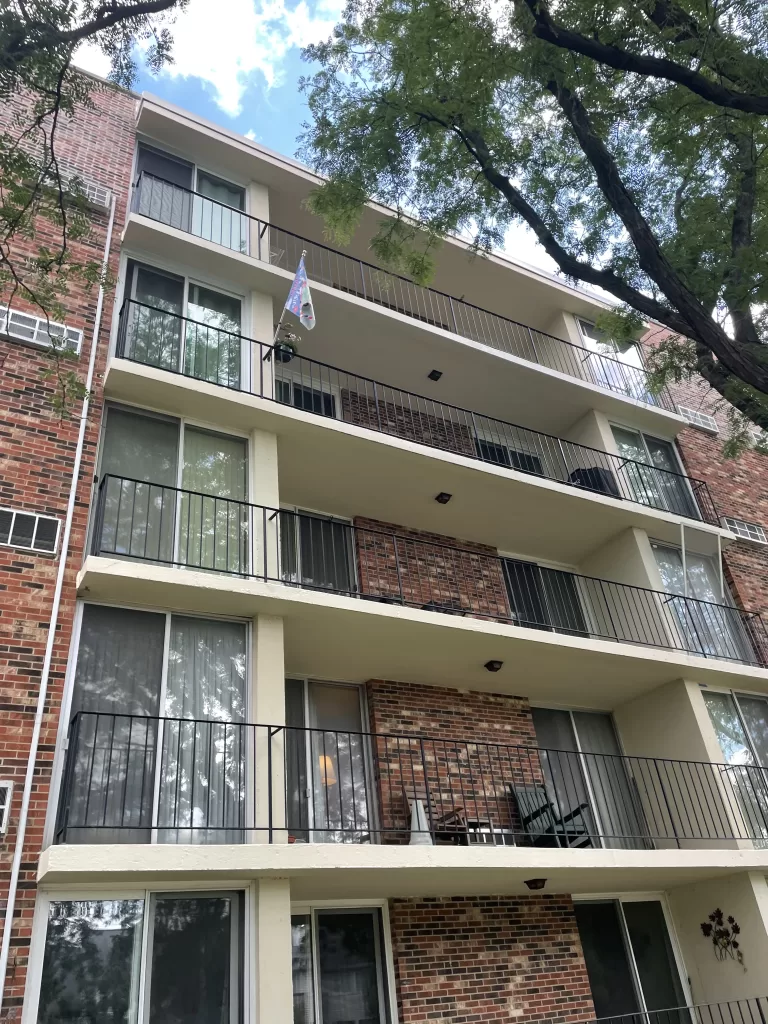 Balcony renovation project with updated railings and waterproof coating