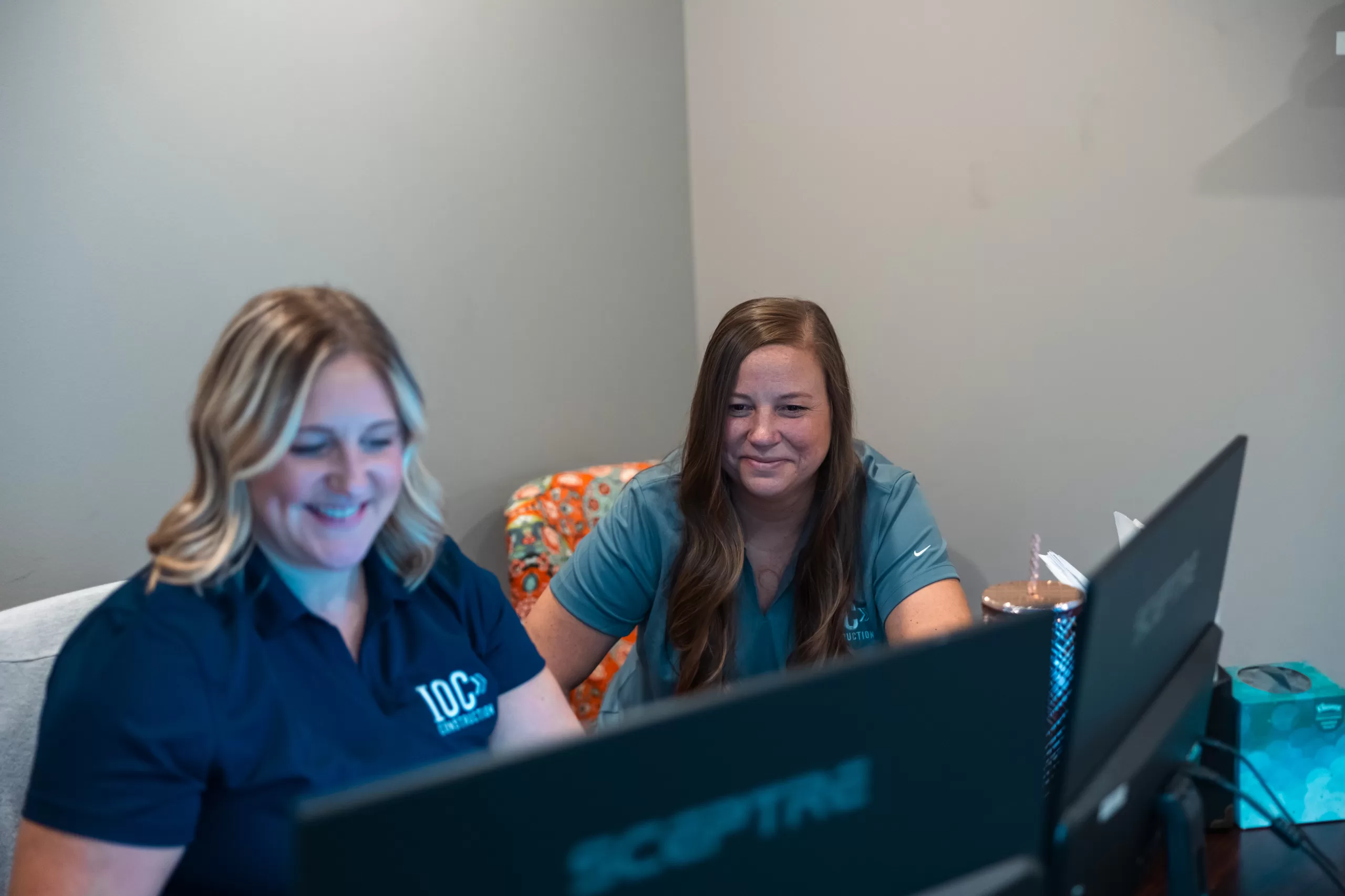 Team reviewing digital plans for ongoing commercial construction project.