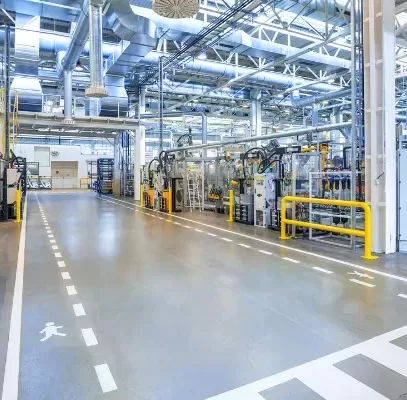 Industrial manufacturing space with polished concrete floor and overhead lighting